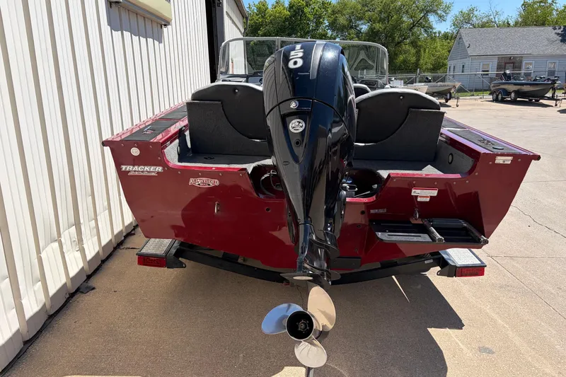 Slide: The Image of 2016 Bass Tracker Tournament V-18 boat with powerful outboard motor, parked outdoors. - 3