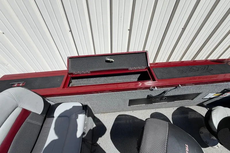 Slide: The Image of 2016 Bass Tracker Tournament V-18 boat interior with open storage compartment. - 9
