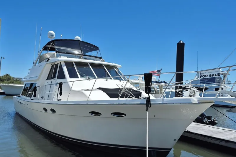 The Image of 2008 Meridian 490 Pilothouse yacht docked, with "For Sale" sign visible in background. - 0