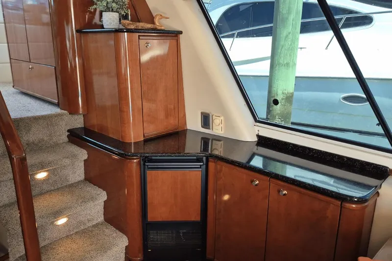 Slide: The Image of Luxurious interior of 2008 Meridian 490 Pilothouse with wood cabinetry and carpeted stairs. - 12