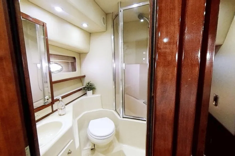 Slide: The Image of Luxurious bathroom in 2008 Meridian 490 Pilothouse yacht with shower and wooden accents. - 13