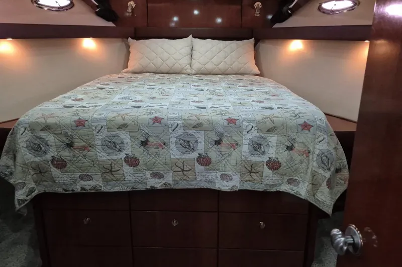 Slide: The Image of Cozy bedroom in 2008 Meridian 490 Pilothouse yacht with nautical-themed bedding. - 17