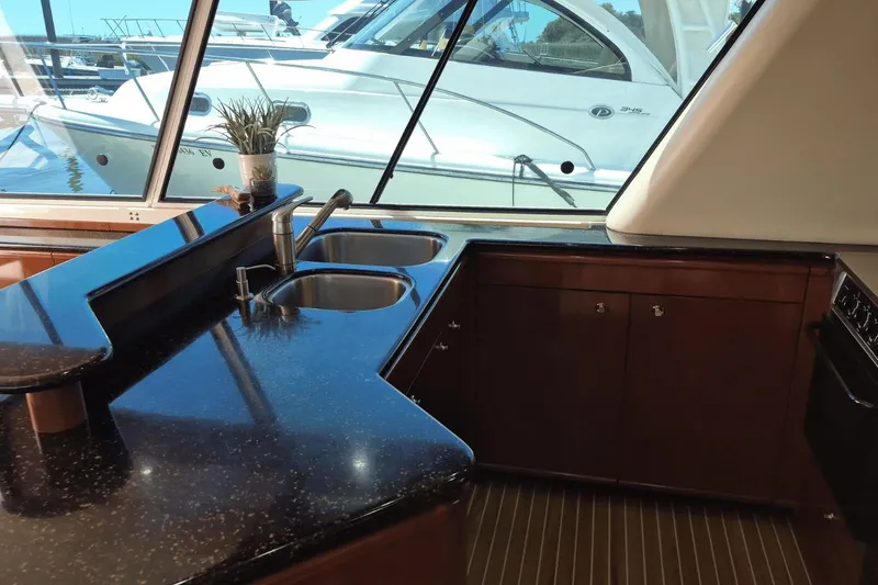 Slide: The Image of Luxurious 2008 Meridian 490 Pilothouse yacht interior with sleek kitchen and dual sinks. - 22