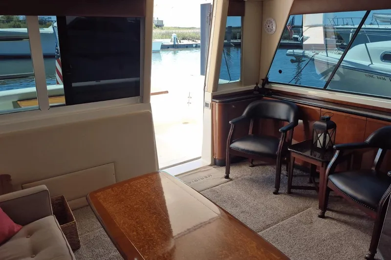 Slide: The Image of Interior of 2008 Meridian 490 Pilothouse yacht with elegant seating and waterfront view. - 24