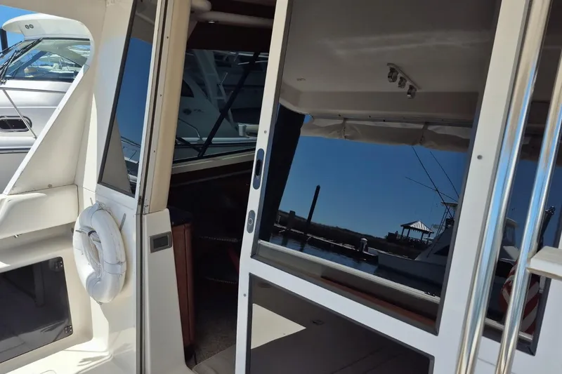 Slide: The Image of 2008 Meridian 490 Pilothouse yacht with open sliding door and dockside view. - 26