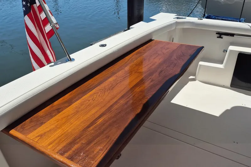 Slide: The Image of 2008 Meridian 490 Pilothouse boat deck with wooden table and American flag. - 27