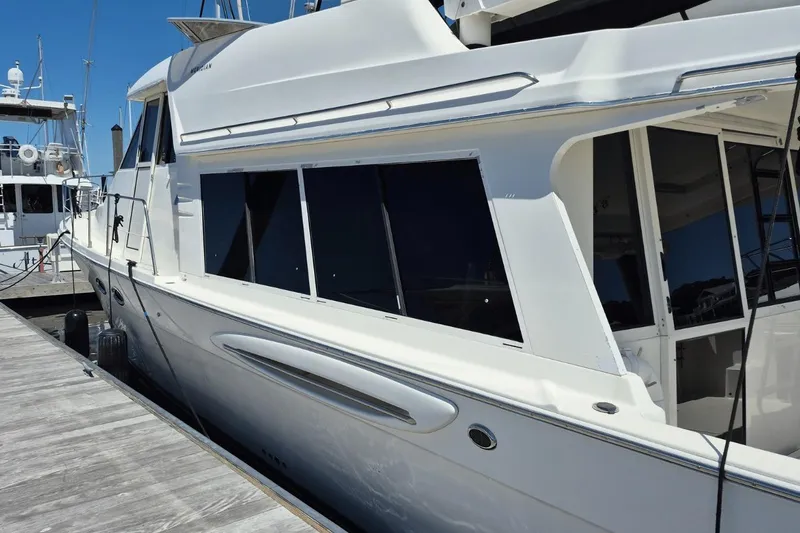 Slide: The Image of 2008 Meridian 490 Pilothouse yacht docked at marina under clear blue sky. - 29