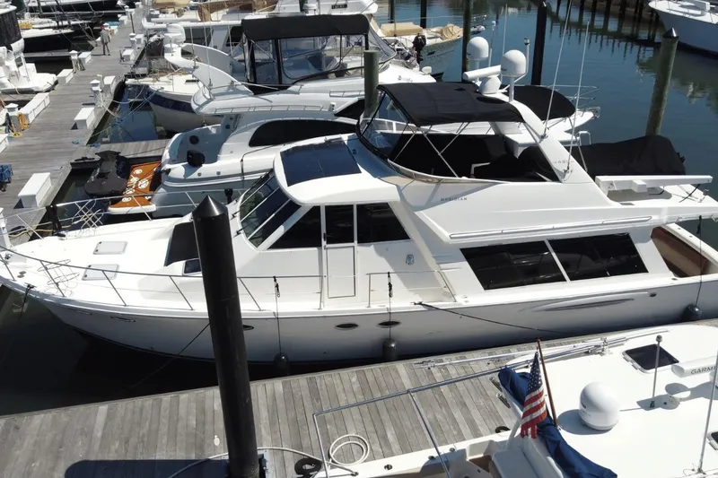 Slide: The Image of 2008 Meridian 490 Pilothouse yacht docked at marina, surrounded by other boats. - 32