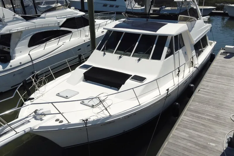 Slide: The Image of 2008 Meridian 490 Pilothouse yacht docked at marina, showcasing sleek design and spacious deck. - 33
