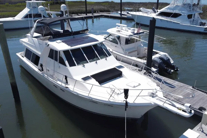 Slide: The Image of 2008 Meridian 490 Pilothouse yacht docked at marina, surrounded by other boats. - 34