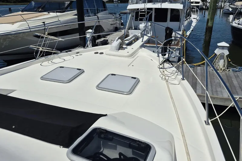Slide: The Image of 2008 Meridian 490 Pilothouse yacht docked at marina, showcasing sleek deck design. - 4
