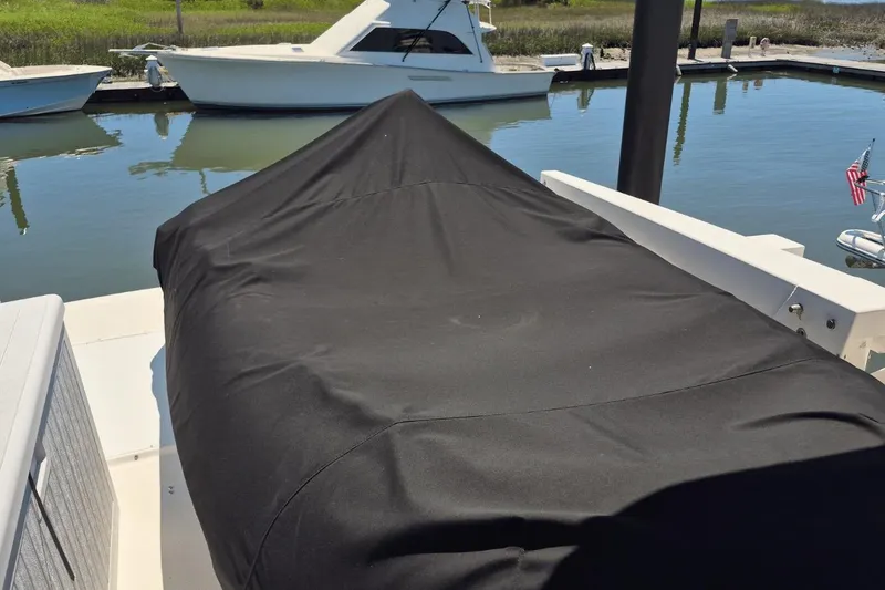 Slide: The Image of Covered area on a 2008 Meridian 490 Pilothouse yacht docked by the water. - 5