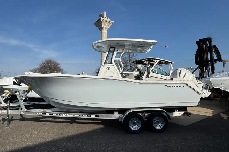 The Image of 2026 Tidewater 232 SS boat on trailer, displayed outdoors under clear blue sky. - 1