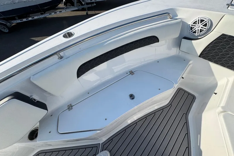 Slide: The Image of 2026 Tidewater 232 SS boat interior with seating, speaker, and storage compartment. - 14