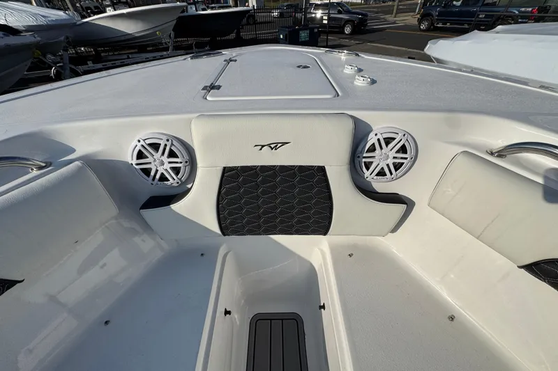 Slide: The Image of 2026 Tidewater 232 SS boat interior with speakers and cushioned seating. - 16