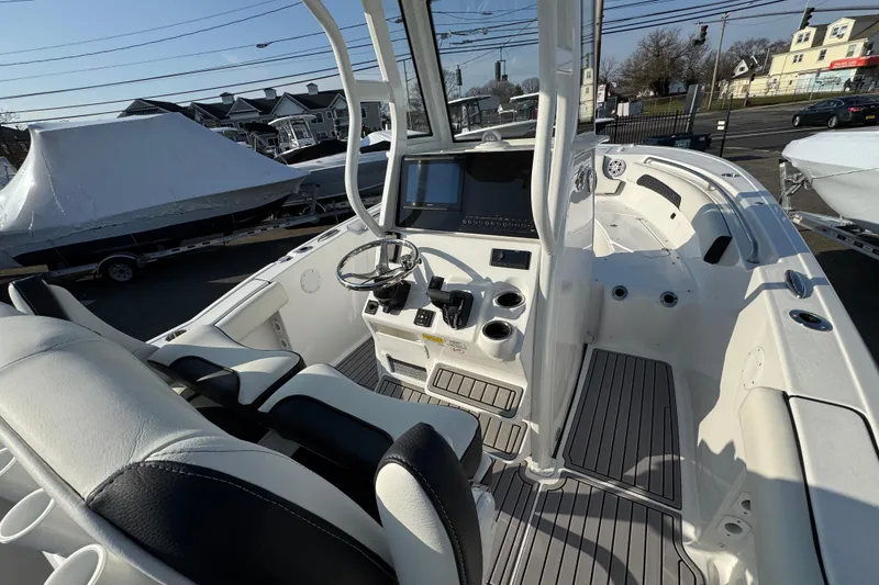 Slide: The Image of 2026 Tidewater 232 SS boat interior with modern helm and seating. - 25