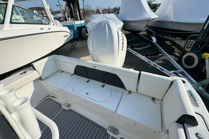Slide: The Image of 2026 Tidewater 232 SS boat with Yamaha engine, docked among other boats. - 3
