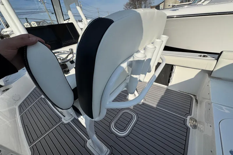 Slide: The Image of 2026 Tidewater 232 SS boat interior with white seating and rod holders. - 4