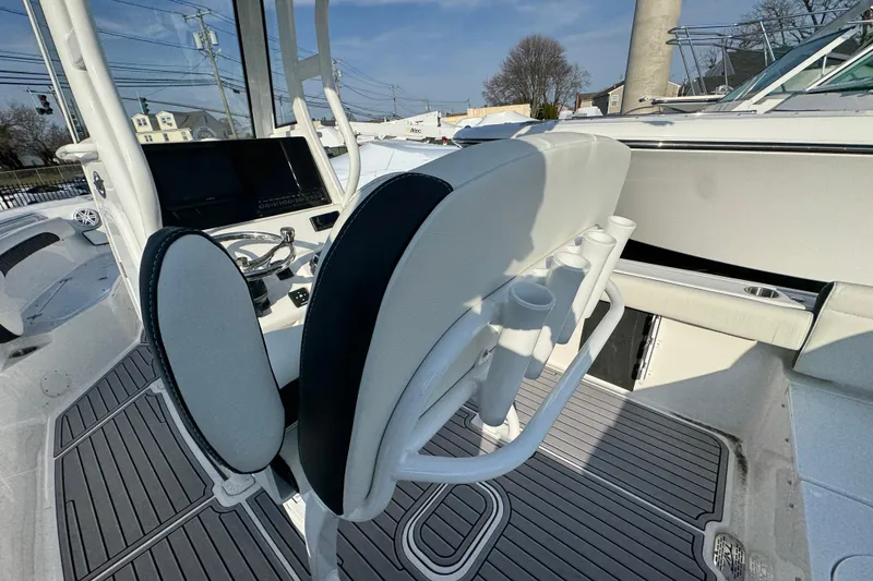 Slide: The Image of 2026 Tidewater 232 SS boat interior with helm, seating, and rod holders. - 5