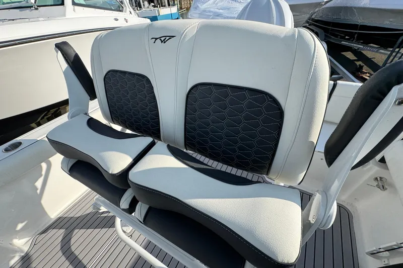 Slide: The Image of 2026 Tidewater 232 SS boat seating with stylish black and white upholstery. - 7