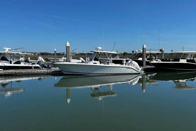 Slide: The Image of 2024 Pursuit S 288 Sport boat docked in a serene marina setting. - 15