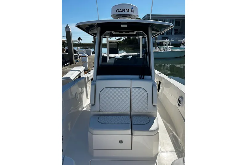 Slide: The Image of 2024 Pursuit S 288 Sport boat with Garmin equipment, docked at marina. - 2