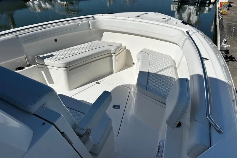 Slide: The Image of 2024 Pursuit S 288 Sport boat interior with white cushioned seating and sleek design. - 4