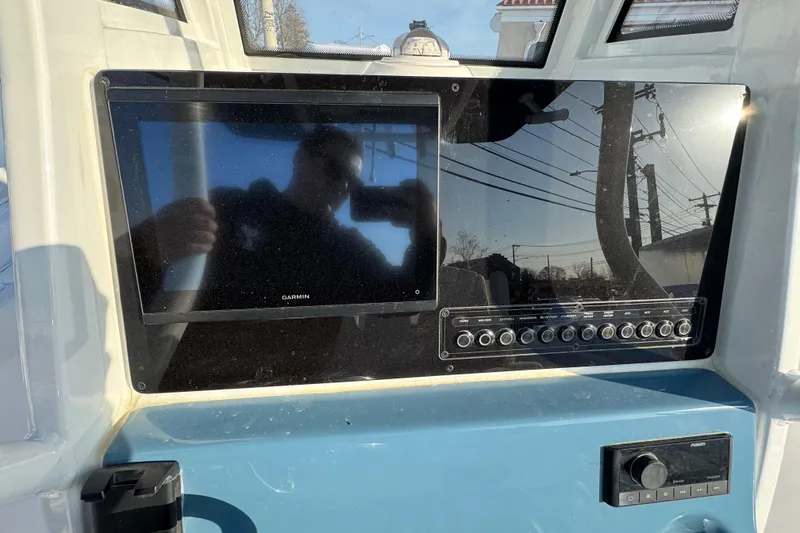 Slide: The Image of 2026 Tidewater 232 LXF boat dashboard with Garmin display and control panel. - 12