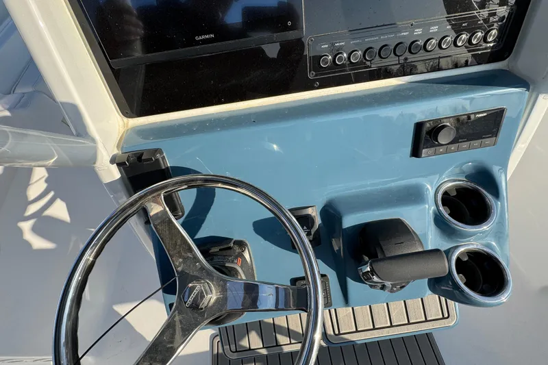 Slide: The Image of Helm of 2026 Tidewater 232 LXF boat with steering wheel and controls. - 13
