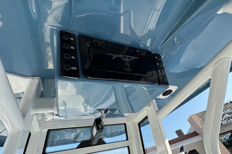 Slide: The Image of 2026 Tidewater 232 LXF boat console with blue finish and control panel. - 16