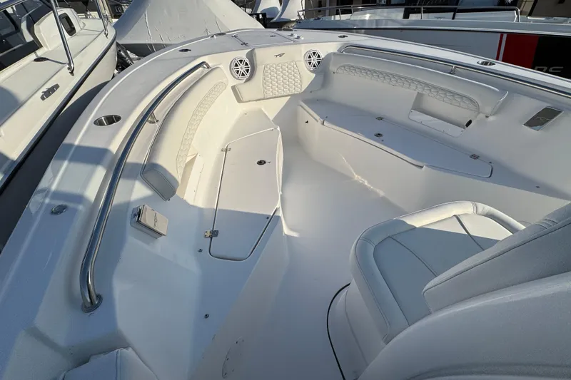 Slide: The Image of 2026 Tidewater 232 LXF boat interior with white seating and stainless steel railings. - 18
