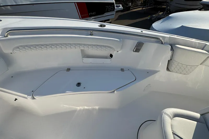 Slide: The Image of Interior view of a 2026 Tidewater 232 LXF boat, featuring sleek seating and storage. - 19