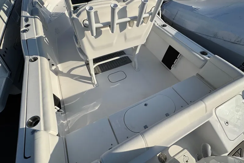 Slide: The Image of 2026 Tidewater 232 LXF boat interior with rod holders and seating area. - 2