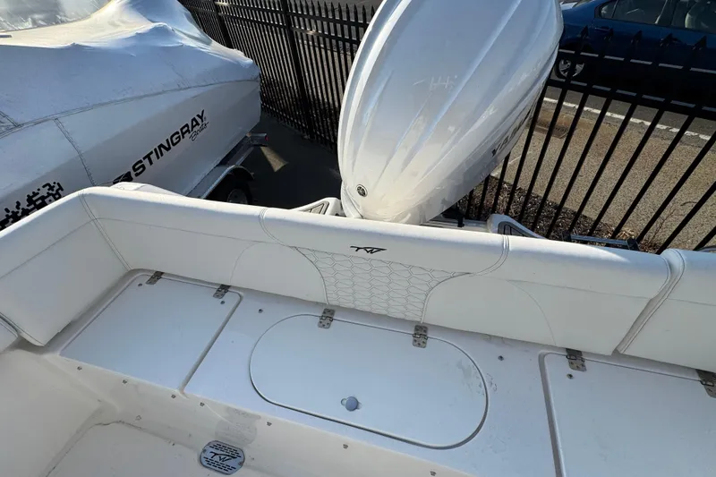 Slide: The Image of 2026 Tidewater 232 LXF boat with white seating and outboard motor. - 4