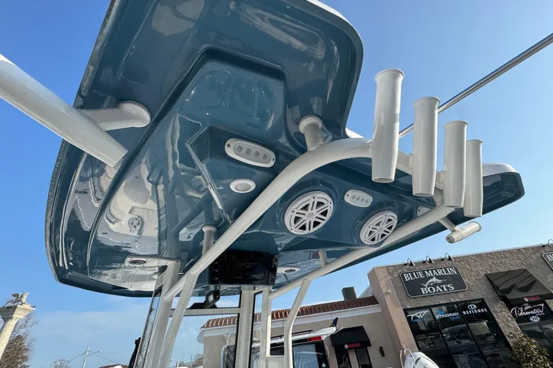 Slide: The Image of 2026 Tidewater 232 LXF boat with rod holders and speakers, viewed from below. - 7