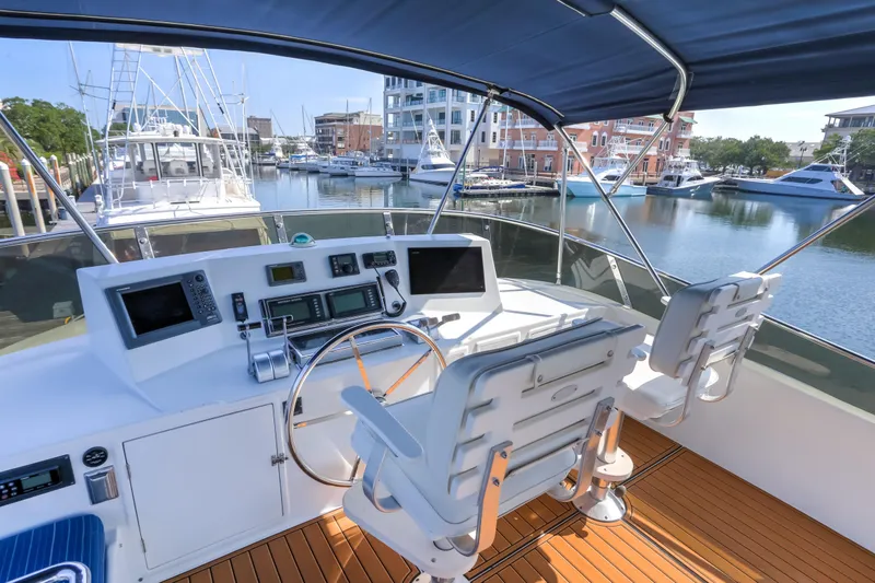 Slide: The Image of Helm of 2003 Jefferson Pilothouse 57 yacht in marina, featuring modern navigation equipment. - 19