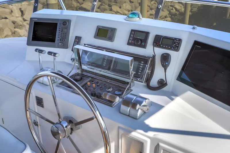 Slide: The Image of Helm of 2003 Jefferson Pilothouse 57 yacht with navigation instruments and steering wheel. - 20