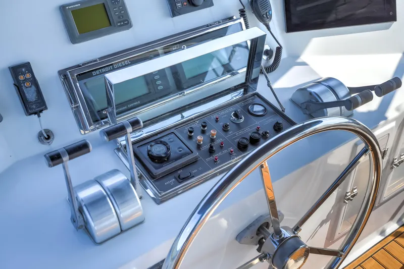 Slide: The Image of Control panel of a 2003 Jefferson Pilothouse 57 yacht with steering wheel and navigation instruments. - 24