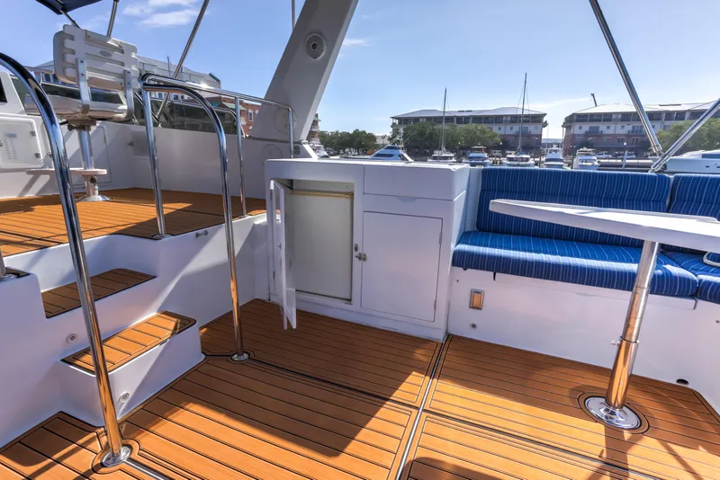 Slide: The Image of Luxurious 2003 Jefferson Pilothouse 57 yacht interior with wooden deck and blue seating. - 28