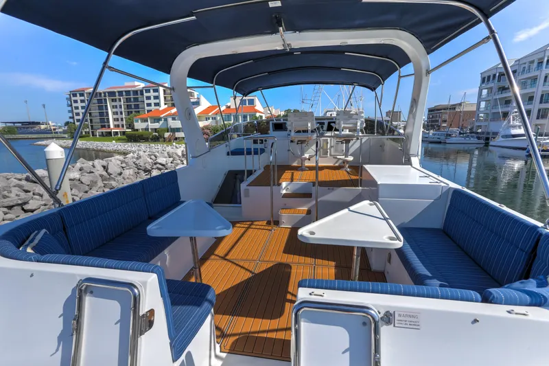 Slide: The Image of Spacious deck of 2003 Jefferson Pilothouse 57 yacht with blue seating and tables. - 31