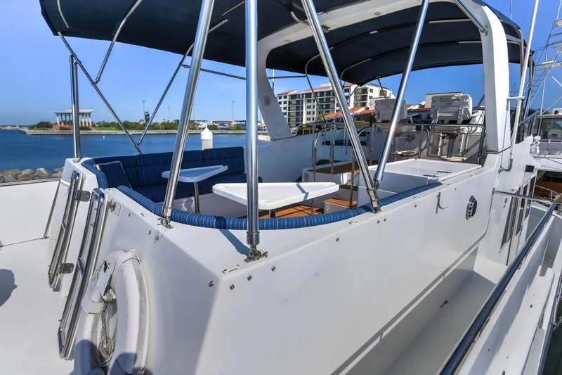 Slide: The Image of 2003 Jefferson Pilothouse 57 yacht with spacious deck and seating, docked at marina. - 35