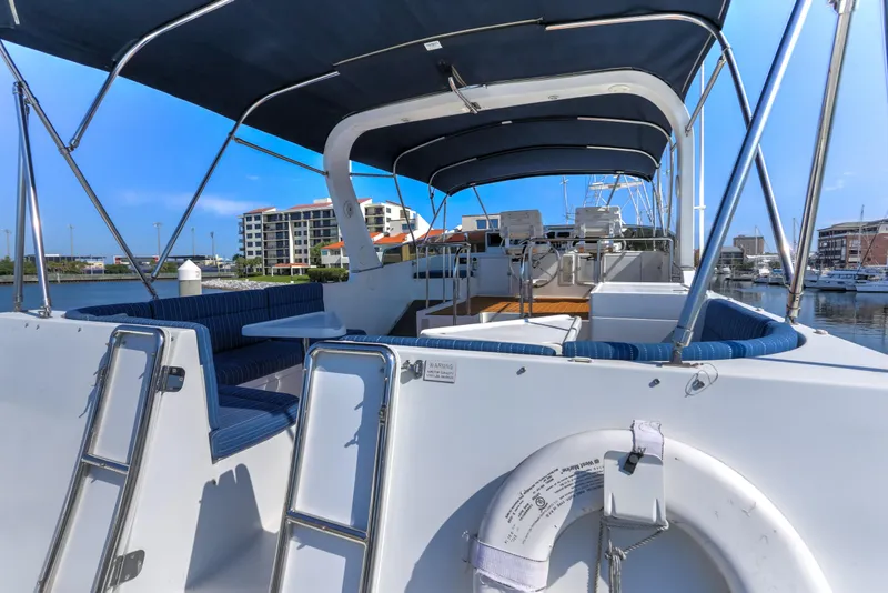 Slide: The Image of 2003 Jefferson Pilothouse 57 yacht with spacious deck and seating, docked at marina. - 36