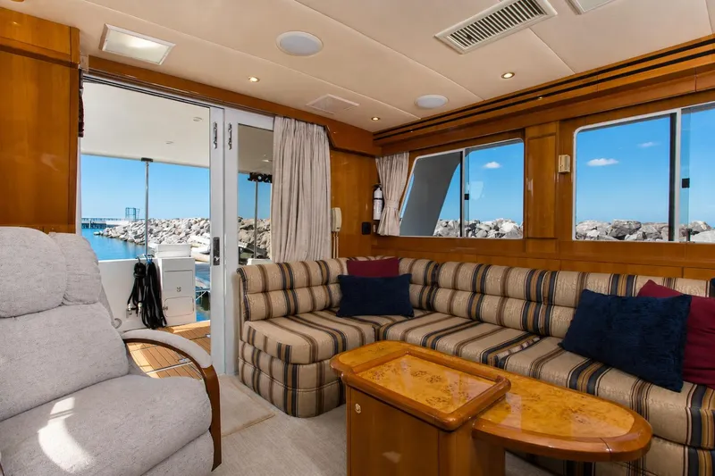 Slide: The Image of Luxurious interior of 2003 Jefferson Pilothouse 57 yacht with plush seating and ocean view. - 41