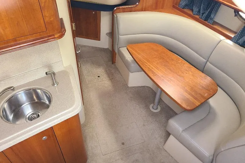 Slide: The Image of Interior of 2006 Cruisers Yachts 3470 Express with kitchenette and cozy seating area. - 18