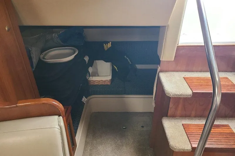 Slide: The Image of Interior of 2006 Cruisers Yachts 3470 Express with storage area and carpeted stairs. - 3