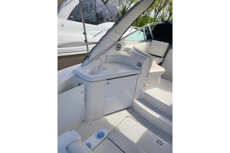 Slide: The Image of 2006 Cruisers Yachts 3470 Express interior with seating and sink area, showcasing luxury design. - 6