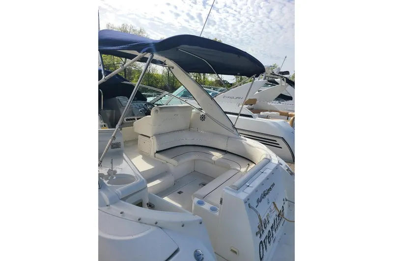 Slide: The Image of 2006 Cruisers Yachts 3470 Express with spacious seating and canopy, docked outdoors. - 7