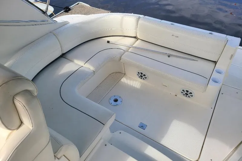 Slide: The Image of 2006 Cruisers Yachts 3470 Express interior with white seating and cup holders. - 8