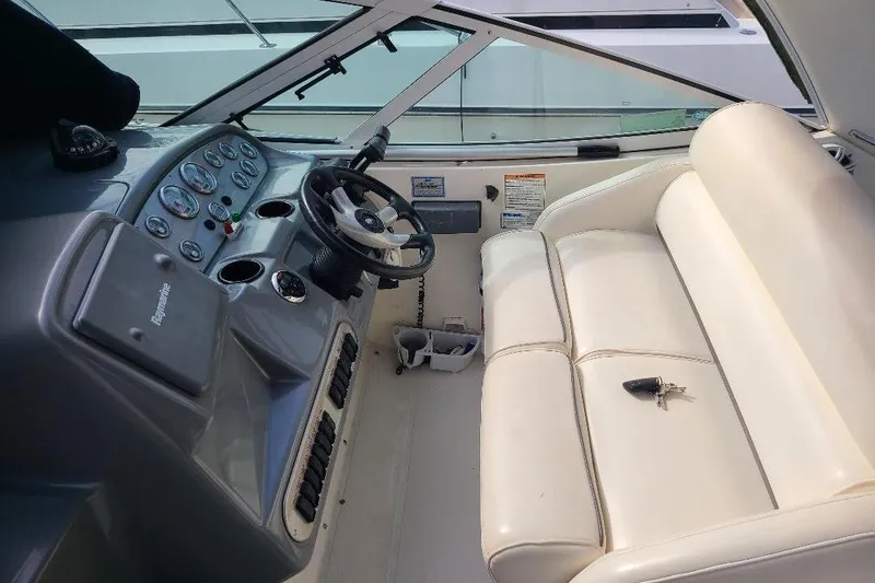 Slide: The Image of Interior of 2006 Cruisers Yachts 3470 Express with steering wheel and white seating. - 9