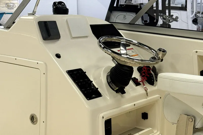 Slide: The Image of Steering console of the 2024 Cobia 220 Dual Console boat. - 10